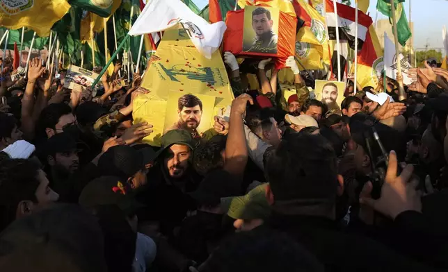 Members from the Popular Mobilization Forces carrying the coffin of Hussein Khalil, a former aide to the late Hezbollah Secretary-General Hassan Nasrallah who killed with Iraqi commander Haider al-Moussawi from Kataeb Sayyed Al-Shuhada by an Israeli airstrike inside Iran, in Baghdad, Iraq, Sunday, June 22, 2025. (AP Photo/Hadi Mizban)