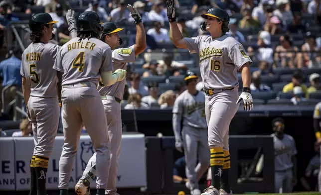 The Athletics celebrate Nick Kurtz' (16) three run home run during the sixth inning of a baseball game against the New York Yankees, Saturday, June 28, 2025, in New York. (AP Photo/Angelina Katsanis)