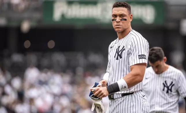 New York Yankees' Aaron Judge (99) takes off his gloves after grounding into double play during the first inning of a baseball game against the Athletics, Saturday, June 28, 2025, in New York. (AP Photo/Angelina Katsanis)