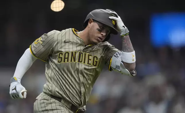 San Diego Padres' Manny Machado rounds the bases after hitting a solo home run during the seventh inning of a baseball game against the Milwaukee Brewers, Sunday, June 8, 2025, in Milwaukee. (AP Photo/Aaron Gash)