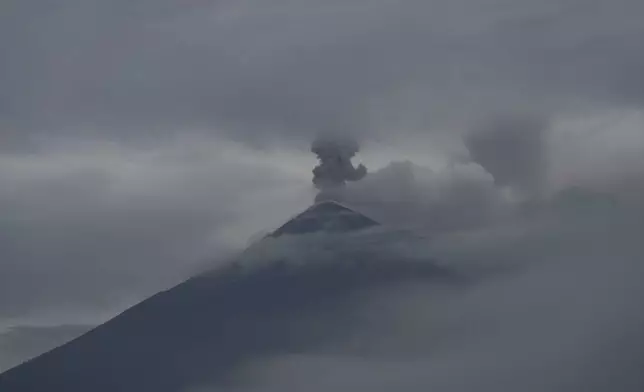 The Fuego Volcano blows out a cloud of ash, as seen from San Juan Alotenango, Guatemala, Thursday, June 5, 2025. (AP Photo/Moises Castillo)