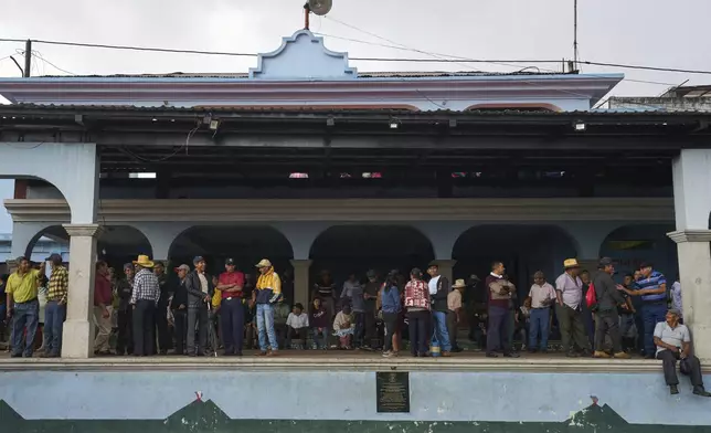 Families evacuated from the area surrounding the Fuego Volcano stand in a temporary shelter in San Juan Alotenango, Guatemala, Thursday, June 5, 2025, after the volcano erupted. (AP Photo/Moises Castillo)