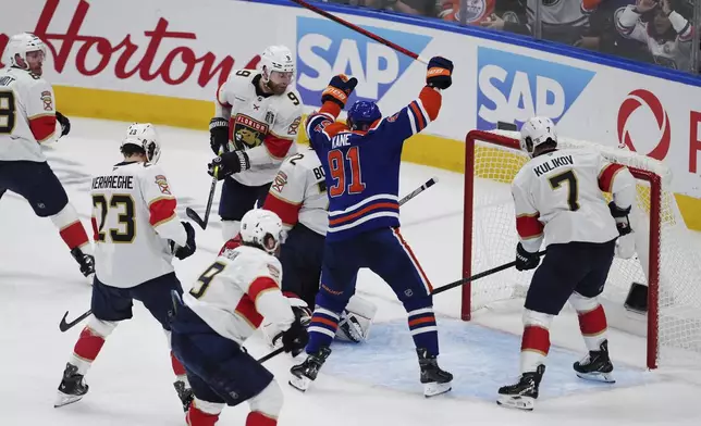 Edmonton Oilers' Evander Kane (91) celebrates Mattias Ekholm's (not shown) goal against Florida Panthers goalie Sergei Bobrovsky (72) during the third period in Game 1 of the NHL Stanley Cup Final, in Edmonton, on Wednesday, June 4, 2025. (Darryl Dyck/The Canadian Press via AP)