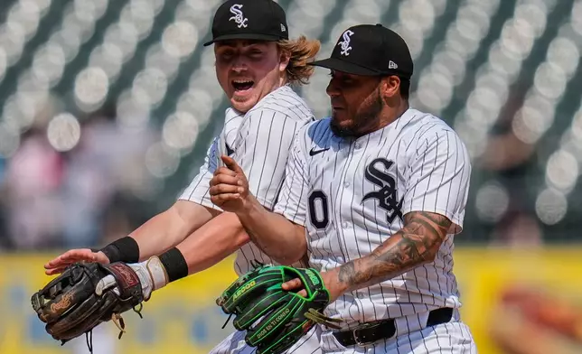 Chicago White Sox shortstop Chase Meidroth, left, and second baseman Lenyn Sosa celebrate their team's win over the Arizona Diamondbacks following a baseball game Wednesday, June 25, 2025, in Chicago. (AP Photo/Erin Hooley)