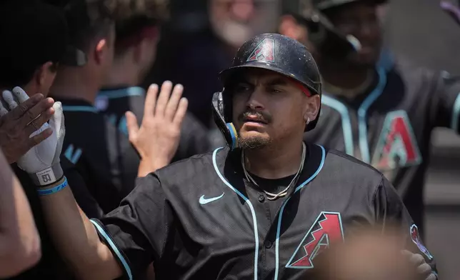 Arizona Diamondbacks' Josh Naylor (22) celebrates after hitting two-run home run during the first inning of a baseball game against the Chicago White Sox, Wednesday, June 25, 2025, in Chicago. (AP Photo/Erin Hooley)