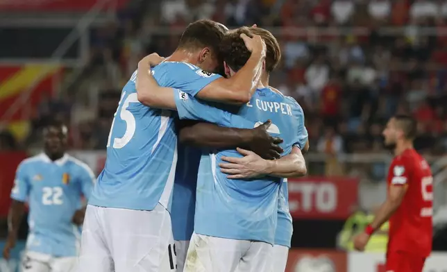 Belgium's Maxim De Cuyper, center, celebrates with teammates after scoring the opening goal during a World Cup 2026 group J qualifying soccer match between North Macedonia and Belgium at National Arena Todor Proeski in Skopje, North Macedonia, Friday, June 6, 2025. (AP Photo/Boris Grdanoski)