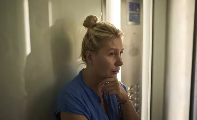 Ukrainian makeup artist Tetiana Kurakova, 40, takes the elevator in a hotel in Tel Aviv, Israel, June 17, 2025, that was turned into a shelter for evacuees from Bat Yam, which was hit by an Iranian strike. (AP Photo/Leo Correa)