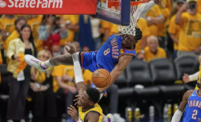 Indiana Pacers guard Bennedict Mathurin is fouled by Oklahoma City Thunder forward Jalen Williams (8) during the second half of Game 4 of the NBA Finals basketball series, Friday, June 13, 2025, in Indianapolis. (AP Photo/Abbie Parr)