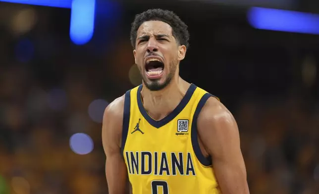 Indiana Pacers guard Tyrese Haliburton reacts after making a three pointer against the Oklahoma City Thunder during the second half of Game 3 of the NBA Finals basketball series, Wednesday, June 11, 2025, in Indianapolis. (AP Photo/Michael Conroy)