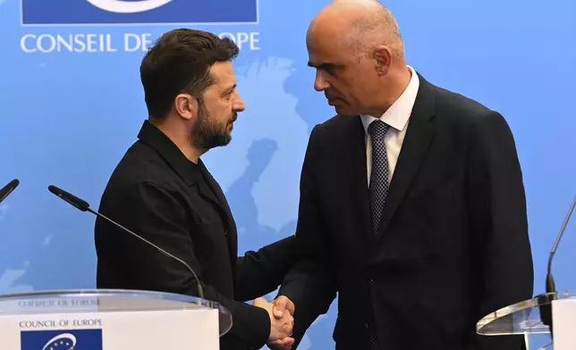 Ukraine's President Volodymyr Zelenskyy, left, shakes hands with Alain Berset, secretary General of the Council of Europe, as he arrives for a press conference at the Council of Europe after signing the legal instruments necessary to launch the Special Tribunal for the Crime of Aggression against Ukraine, in Strasbourg, eastern France, Wednesday, June 25, 2025. (AP Photo/Pascal Bastien)