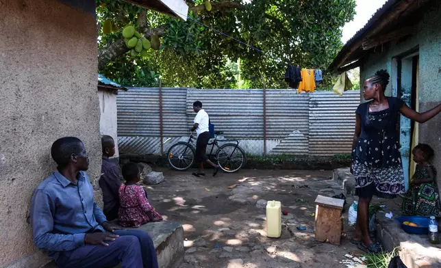 Susan Apio, Community Health Extension Worker, riding buffalo bicycle through alley in Lira district, Uganda, May 19, 2025. (AP Photo/Hajarah Nalwadda)