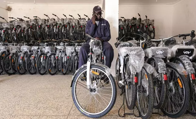 Odongo Francis, Sales Representative for Buffalo Bicycle Uganda, speaks on phone in Lira district, Uganda, May 19, 2025. (AP Photo/Hajarah Nalwadda)