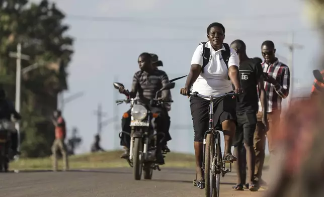 Lucy Abalo, Community Health Extension Worker riding her Buffalo bicycle in Lira, Uganda, May 19, 2025. (AP Photo/Hajarah Nalwadda)