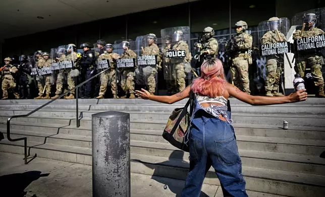 A protester taunts a line of California National Guard protecting a federal building in downtown Los Angeles on Monday, June 9, 2025. (AP Photo/Eric Thayer)