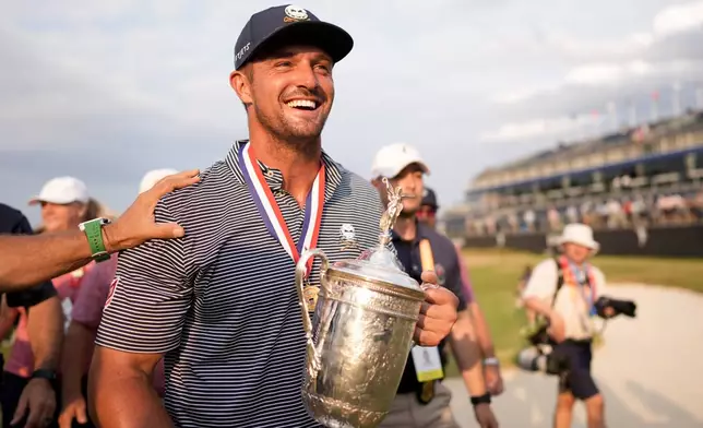 FILE - Bryson DeChambeau holds the trophy after winning the U.S. Open golf tournament Sunday, June 16, 2024, in Pinehurst, N.C. (AP Photo/Mike Stewart, File)