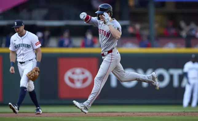 Boston Red Sox's Roman Anthony, center, rounds the bases on his solo home run off Seattle Mariners starting pitcher Logan Gilbert during the first inning of a baseball game Monday, June 16, 2025, in Seattle. (AP Photo/John Froschauer)