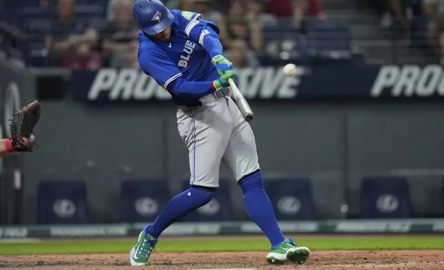 Toronto Blue Jays' George Springer hits a home run in the eighth inning of a baseball game against the Cleveland Guardians in Cleveland, Tuesday, June 24, 2025. (AP Photo/Sue Ogrocki)