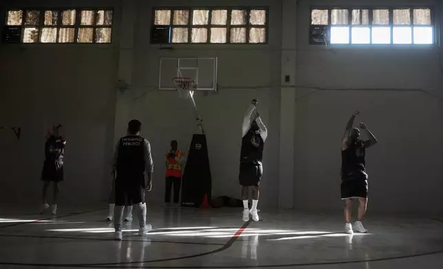 Twinning Project cohort 2 participants perform basketball drills during the project's collaboration with the Golden State Warriors and the California Department of Corrections and Rehabilitation at Solano State Prison in Vacaville, Calif., Tuesday, Feb. 11, 2025. (AP Photo/Jeff Chiu)