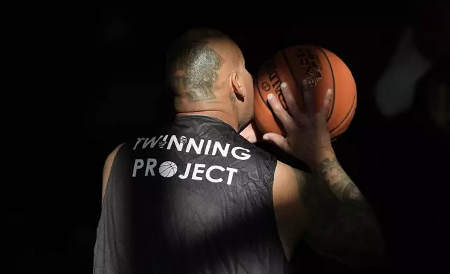 Daniel Lopez performs a basketball drill with other Twinning Project cohort 2 participants during the project's collaboration with the NBA's Golden State Warriors and the California Department of Corrections and Rehabilitation at Solano State Prison in Vacaville, Calif., Tuesday, Feb. 11, 2025. (AP Photo/Jeff Chiu)