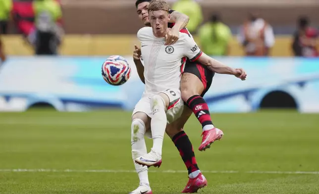 Chelsea's Cole Palmer, front, and Flamengo's Ayrton Lucas fight for the ball during the Club World Cup Group D soccer match between Flamengo and Chelsea in Philadelphia, Friday, June 20, 2025. (AP Photo/Derik Hamilton)
