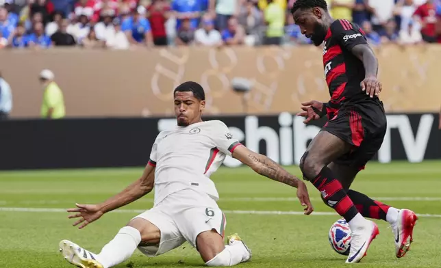 Flamengo's Gerson fakes Chelsea's Levi Colwill during the Club World Cup Group D soccer match between Flamengo and Chelsea in Philadelphia, Friday, June 20, 2025. (AP Photo/Derik Hamilton)