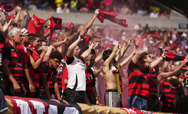 Flamingo fans burn torches during the Club World Cup Group D soccer match between Flamengo and Chelsea in Philadelphia, Friday, June 20, 2025. (AP Photo/Derik Hamilton)