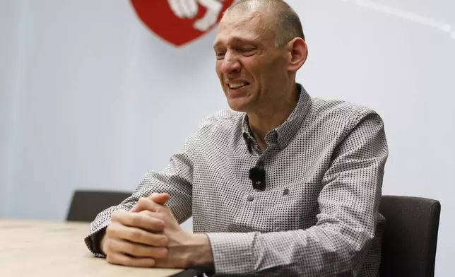 Syarhei Tsikhanouski, a Belarusian opposition activist released from a prison by Belarusian authorities, cries during an interview with the Associated Press in Vilnius, Lithuania, Sunday, June 22, 2025. (AP Photo/Mindaugas Kulbis)