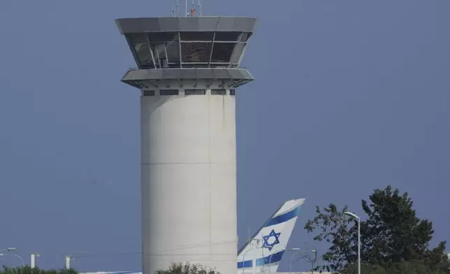 Israel's national airline El AL aircraft is seen next to the control tower at Cyprus' main airport in Larnaca, Saturday, June 14, 2025. (AP Photo/Petros Karadjias)