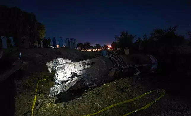 Remnants of a missile fallen on a field between Najaf and Karbala, Iraq, Friday, June 13, 2025. (AP Photo/Anmar Khalil)