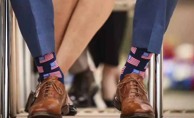 U.S. Defense Secretary Pete Hegseth wears socks showing the American flag during a ceremony at the US cemetery to commemorate the 81st anniversary of the D-Day landings, Friday, June 6, 2025 in Colleville-sur-Mer, Normandy. (AP Photo/Thomas Padilla)