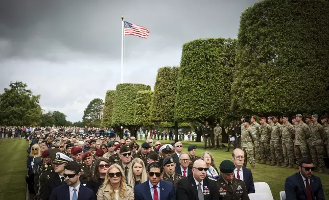 Guests attend a ceremony at the US cemetery to commemorate the 81st anniversary of the D-Day landings, Friday, June 6, 2025 in Colleville-sur-Mer, Normandy. (AP Photo/Thomas Padilla)