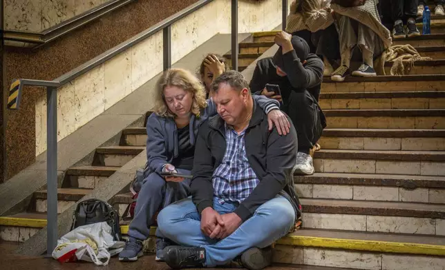 People rest in a metro station, being used as a bomb shelter, during a Russian drones attack in Kyiv, Ukraine, early Friday, June 6, 2025. (AP Photo/Dan Bashakov)