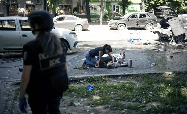 A woman touches the body of a relative killed in a Russian strike on Sumy, Ukraine, on Tuesday, June 3, 2025. (AP Photo/Yehor Kryvoruchko, Kordon Media)