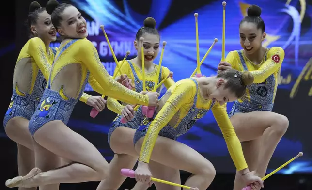 Juniors team of Turkey performs with clubs in the Apparatus final of the European Championships in Rhythmic Gymnastics at the Unibet Arena, Tallinn, Estonia, Wednesday, June 4, 2025. (AP Photo/Sergei Grits)