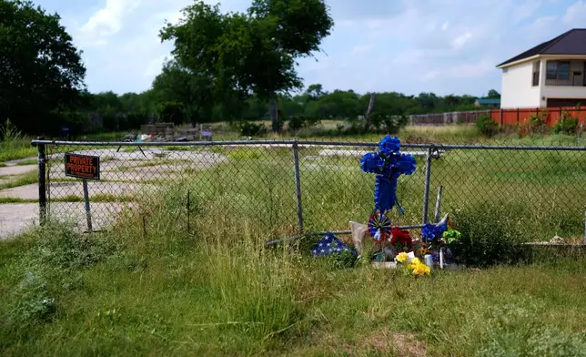 Candles, flowers, and notes are left at a make-shift memorial for voice actor Jonathan Joss who was recently killed, Tuesday, June 3, 2025, in San Antonio. (AP Photo/Eric Gay)