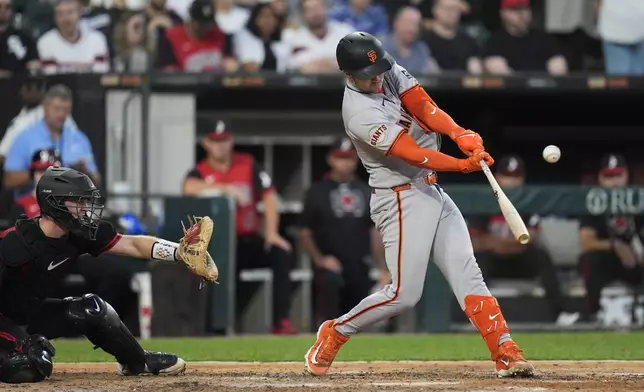 San Francisco Giants' Patrick Bailey (14) hits a two-run triple during the fifth inning of a baseball game against the Chicago White Sox, Friday, June 27, 2025, in Chicago. (AP Photo/Erin Hooley)