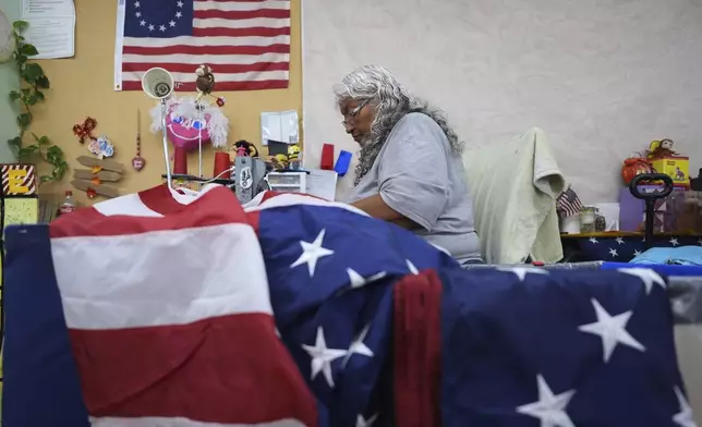 Gloria Ramos sews reinforcement into U.S. flags at Dixie Flag and Banner, Tuesday, June 10, 2025, in San Antonio. (AP Photo/Eric Gay)