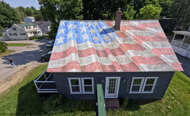 A painting of an American flag decorates the roof of a financial services business, Wednesday, June 11, 2025, in Lewiston, Maine. (AP Photo/Robert F. Bukaty)