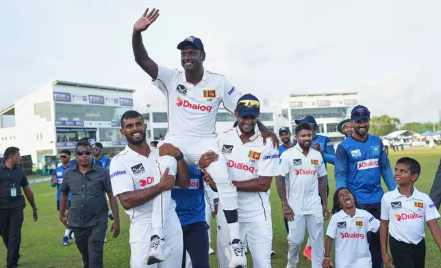Sri Lanka's Angelo Mathews who played his career last test cricket match waves to supporters as teammates carry him around the ground at the end of the first cricket test match between Sri Lanka and Bangladesh in Galle, Sri Lanka, Saturday, June 21, 2025. (AP Photo/Eranga Jayawardena)
