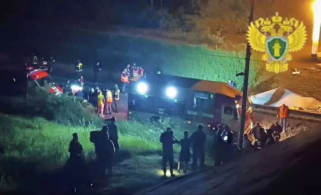 In this photo released by Moscow Interregional Transport Prosecutor's Office telegram channel on Sunday, June 1, 2025, emergency employees work at a damaged bridge in Russia's Bryansk region, which borders Ukraine. (Moscow Interregional Transport Prosecutor's Office telegram channel via AP)