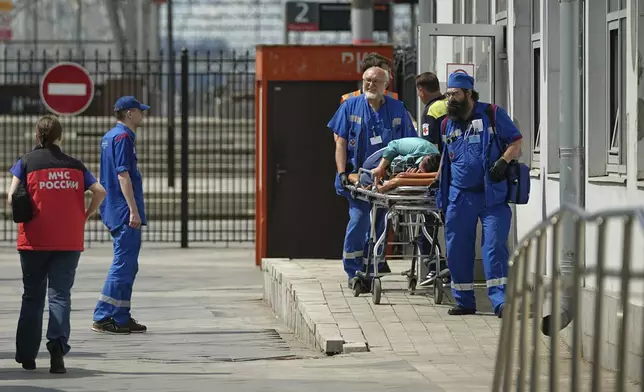 Emergency medics transport a wounded passenger at the railway station in Moscow, Russia, Sunday, June 1, 2025, after a road bridge collapsed on top of a passenger train in the Bryansk region, located on Russia's border with Ukraine. (AP Photo)