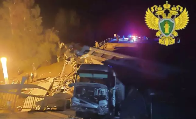 In this photo released by Moscow Interregional Transport Prosecutor's Office telegram channel on Sunday, June 1, 2025, emergency employees work at a damaged bridge in Russia's Bryansk region, which borders Ukraine. (Moscow Interregional Transport Prosecutor's Office telegram channel via AP)
