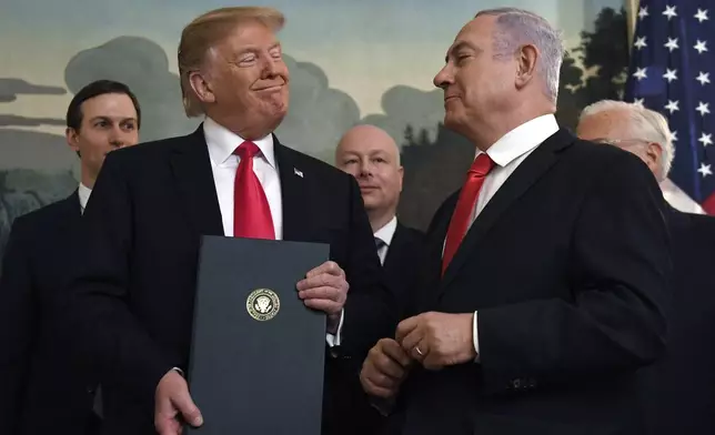 FILE - In this March 25, 2019 file photo, President Donald Trump smiles at Israeli Prime Minister Benjamin Netanyahu, right, after signing a proclamation at the White House in Washington. (AP Photo/Susan Walsh, File)