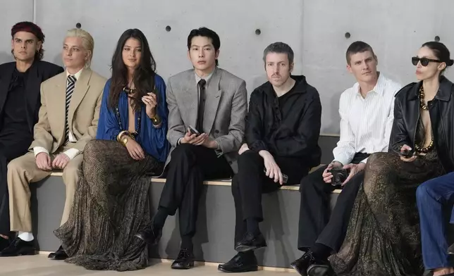 Zel, center, attends the men's Saint Laurent Spring-Summer 2026 collection, that was presented in Paris, Tuesday, June 24, 2025. (AP Photo/Michel Euler)