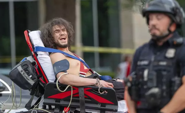 Arturo Gamboa is taken away in handcuffs on a gurney during the “No Kings” protest in Salt Lake City on Saturday, June 14, 2025. (Scott G. Winterton/The Deseret News via AP)