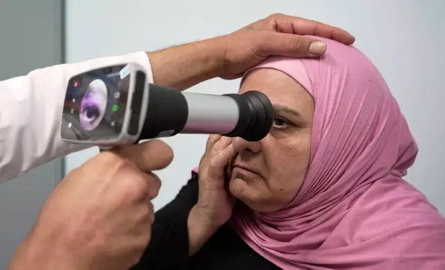 A Palestinian patient undergoes an eye examination at a medical center run by UNRWA in the Mar Elias refugee camp in Beirut, Lebanon, Monday, June 2, 2025. (AP Photo/Hassan Ammar)