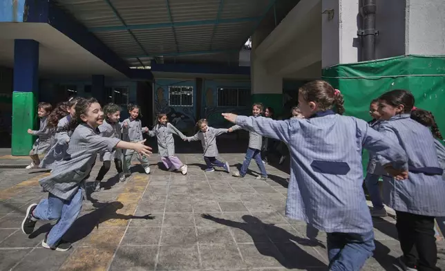 Students play in the courtyard of a primary school run by UNRWA for Palestinian refugees at the Mar Elias refugee camp in Beirut, Lebanon, Monday, June 2, 2025. (AP Photo/Hassan Ammar)