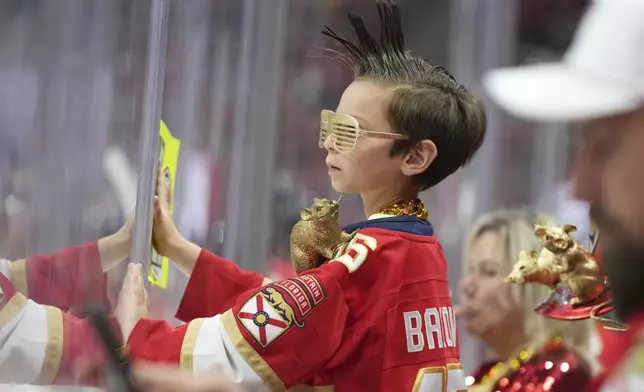 A young Florida Panthers fan watches during the first period in Game 4 of the NHL hockey Stanley Cup Eastern Conference finals against the Carolina Hurricanes, Monday, May 26, 2025, in Sunrise, Fla. (AP Photo/Lynne Sladky)