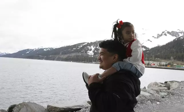 Michael Pese and his daughter Cataleya survey Blackstone Bay in Whittier, Alaska, May 13, 2025. (AP Photo/Mark Thiessen)