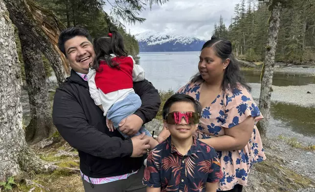 Michael Pese and his wife, Tupe Smith, pose for a photo with their son Maximus and daughter Cataleya in Whittier, Alaska, May 13, 2025. (AP Photo/Mark Thiessen)
